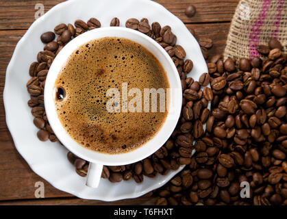 cup of coffee and grain on a rustic table Stock Photo