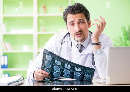 Doctor radiologist looking at x-ray scan in hospital Stock Photo