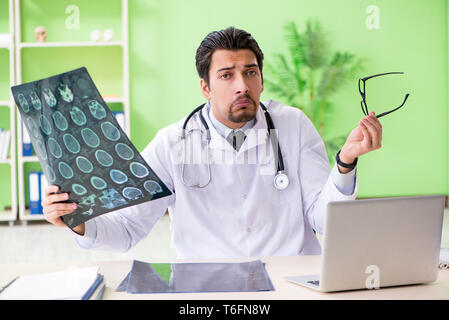 Doctor radiologist looking at x-ray scan in hospital Stock Photo