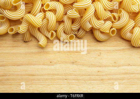 dried pasta on wooden background. Stock Photo