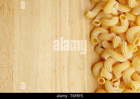 dried pasta on wooden background. Stock Photo