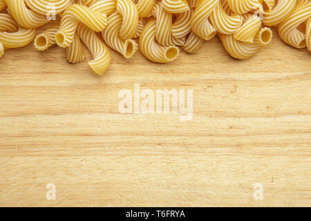 dried pasta on wooden background. Stock Photo