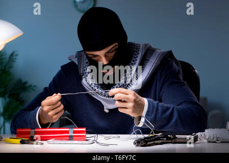 Terrorist bomber preparing dynamite bomb Stock Photo