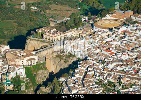 AERIAL VIEW. Historical picturesque city bisected by a deep canyon. Ronda, Andalusia, Spain. Stock Photo