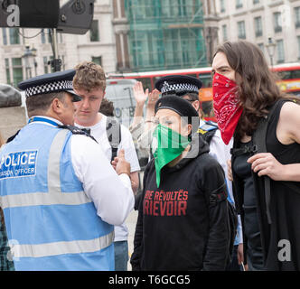 London, UK. 1st May 2019. May Day Labour rally and March with Trade Unions and international organsiations celebrating Labour Day in Trafalgar Square Police had to intervene in the arguments between pro and anti transgender rights protesters Credit: Ian Davidson/Alamy Live News Stock Photo