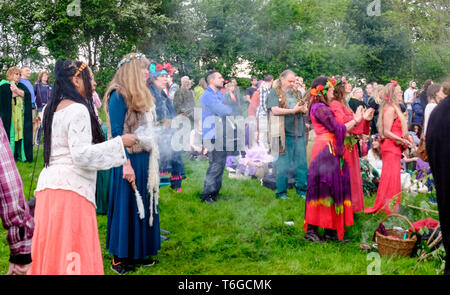 Glastonbury, Somerset, UK. 1st May 2019. Beltane celebrations take place every year between the Spring and Summer equinox on the 1st of May. People meet up, get dressed in green, enjoy a parade, music and dance. The festival has its roots in early Gaelic seasonal celebrations, it fits in well with the new age community that this small Somerset town attracts. They gather around the market cross in the town, the may-pole is presented to the May King and Queen who along with the Green men carry the may-pole to the Chalice Well.  Credit: Mr Standfast/Alamy Live News Stock Photo