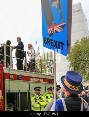 Parliament Square, London, UK, 1st May 2019. Anti Brexit protester Steven Bray tries to contront Labour Leader Jeremy Corbyn over his stance on Brexit following yesterday's Labour NEC announcements. The Labour leader turns to acknowledge Bray, but does not comment. Corbyn was addressing an Extinction Rebellion protest. Credit: Imageplotter/Alamy Live News Stock Photo