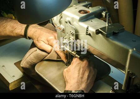 Hands of leather tailor Stock Photo
