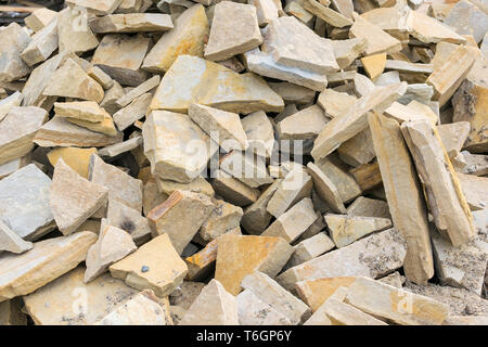 Background, pile, of pieces of roughly broken raw marble stones Stock Photo