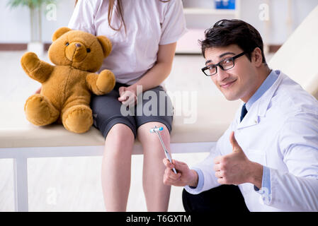 Doctor examining young girl Stock Photo, Royalty Free 