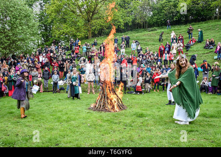 A fire is lit during the Beltane celebrations at Glastonbury Chalice Well, where people gather to observe a modern interpretation of the ancient Celtic pagan fertility rite of Spring. Stock Photo