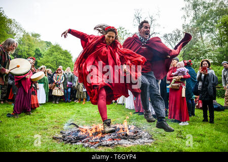 People jump the fire during the Beltane celebrations at Glastonbury