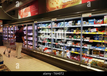 Refrigerater with glass front with fresh products in REWE supermarket Stock Photo