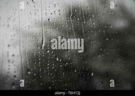 Raindrops from the inside of a train window Stock Photo