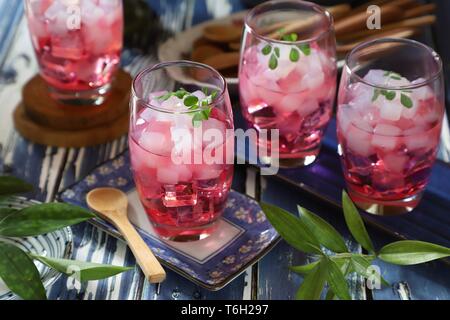 Es Nata de Coco, the Icy Dessert Drink of Coconut Jelly in Red Cocopandan Syrup Stock Photo