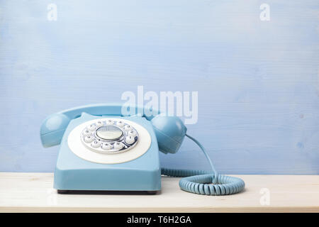 Vintage telephone on wood table background. Rotary antique phone Stock ...