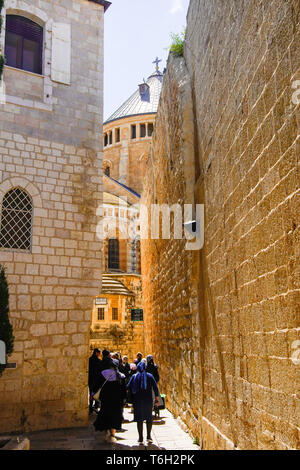 Pilgrims on the way to Dormition Abbey, mount Zion: view of the church from the east, Old Jerusalem, Israel.