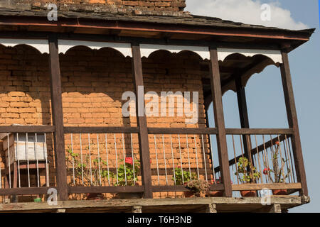 A traditional house Balcony located in the main street of Bandipur in the midday and small balcony wooden steps for passing upstair. Nepal Stock Photo