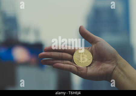 Homeless. Unhappy homeless man with black gloves is holding hand to get bit coins or help food donation from the people. Stock Photo