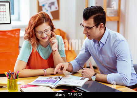 Joyful good looking young people studying together Stock Photo