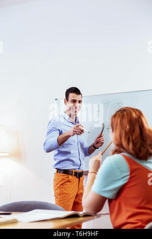 Delighted positive man pointing at this student Stock Photo