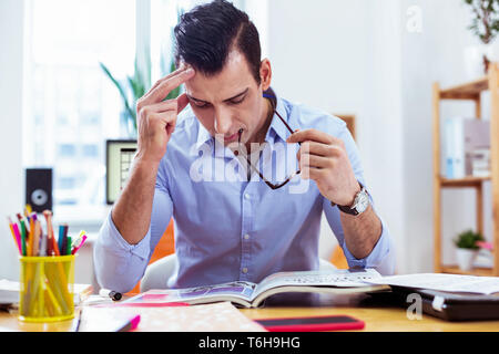 Nice serious man looking into the book Stock Photo