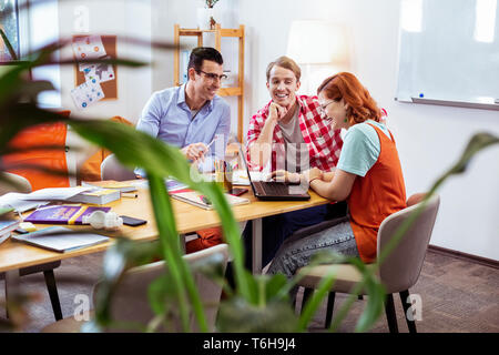 Joyful young people working together in team Stock Photo