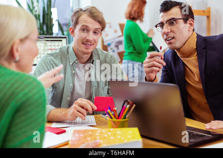 Nice smart pleasant people discussing a problem Stock Photo