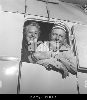 1950s camping. A couple in their caravan looking through the door.  Photo Kristoffersson ref BP39-8. Sweden 1954 Stock Photo