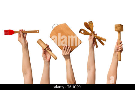 set of the wooden kitchen tools in human hands, on white background Stock Photo