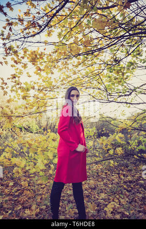 Young beautiful woman in the forest looking around Stock Photo