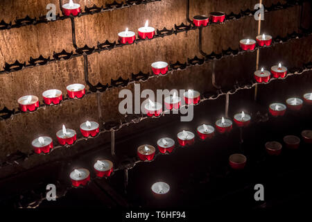Red Memory Candles Burning In Chapel Stock Photo