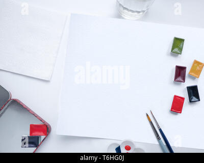 Top view with painting brushes, watercolor paints and blank sheet of paper Stock Photo