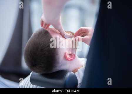 Men's haircut in barbershop. Shave a dangerous razor. Stock Photo