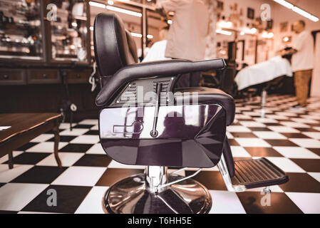 Vintage Barbershop. Work process in hairdressing salon. Armchairs Stock Photo