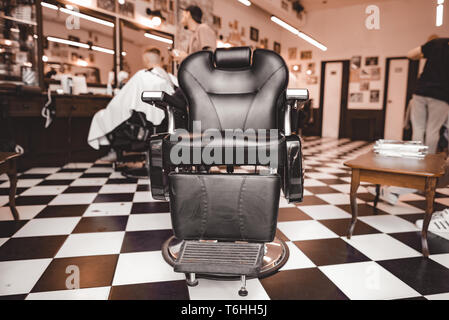 Vintage Barbershop. Work process in hairdressing salon. Armchairs Stock Photo