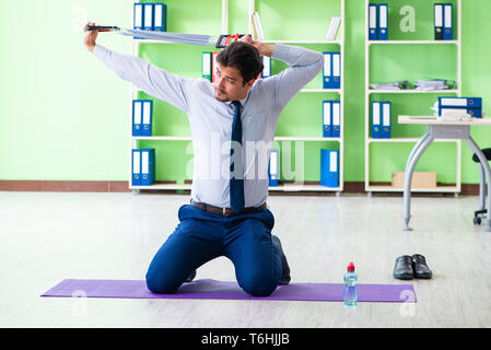 Employee doing exercises during break at work Stock Photo