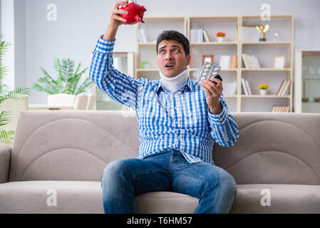 Young man suffering from neck injury at home Stock Photo