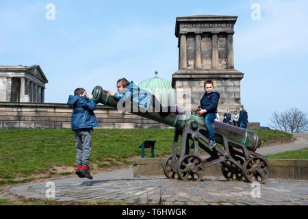 Children playing on the old Portuguese cannon on Calton Hill, Edinburgh, Scotland, UK Stock Photo
