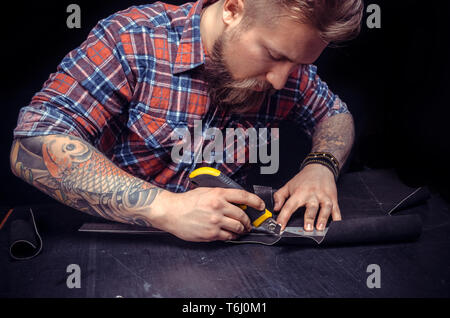 Currier making quality products in his work area Stock Photo