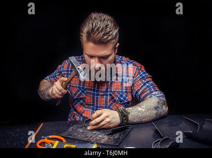 Professional Leather Worker producing leather workpiece Stock Photo
