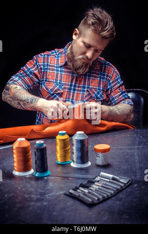 Leather Artist producing a leatherwork Stock Photo