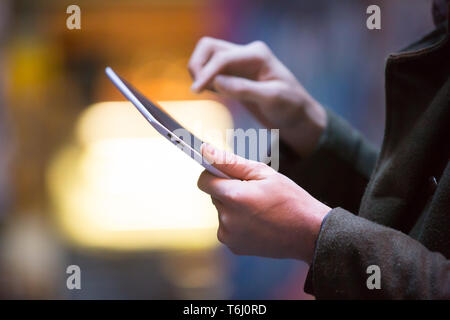 Male using a tablet outside pointing at the screen. Stock Photo