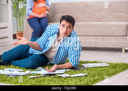 Young family in budget planning concept Stock Photo