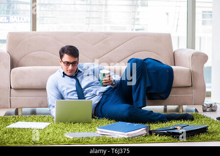 Businessman taking work home and working overtime Stock Photo