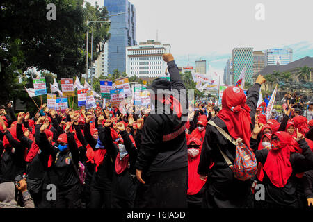 Women labourers and workers are seen shouting slogans while holding placards during the rally. Thousands of workers are urging the government to raise minimum wages and to improve working conditions. Stock Photo