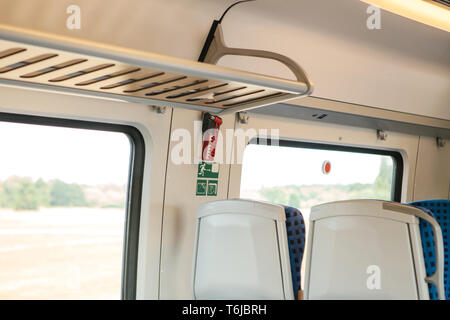 Emergency hammer for emergency breakage of glass and exit in a modern German commuter train. Elements of the interior of the train. Stock Photo