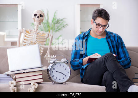 Student studying with skeleton preparing for exams Stock Photo