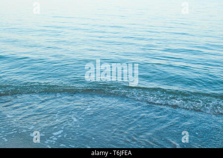 Surface of sea water colored by sunset light. Stock Photo
