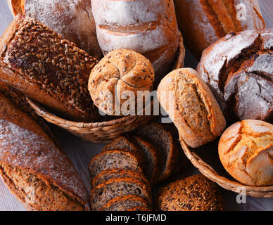 Composition with assorted bakery products in wicker basket Stock Photo